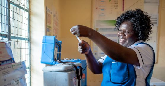 Smiling nurse checking medication