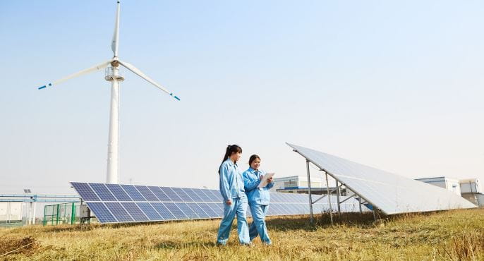 Two engineers walking through a Solar Farm